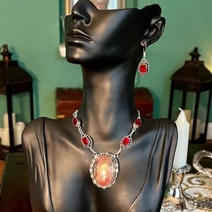 Sterling silver stone pendant necklace with red topaz and matching earrings .